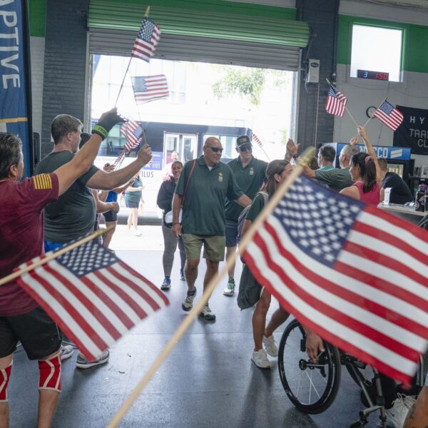 Veterans entering the training gym cheered on by gym members and ATA staff