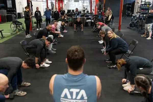 Adaptive Training Academy attendees work through a partner drill during a seminar