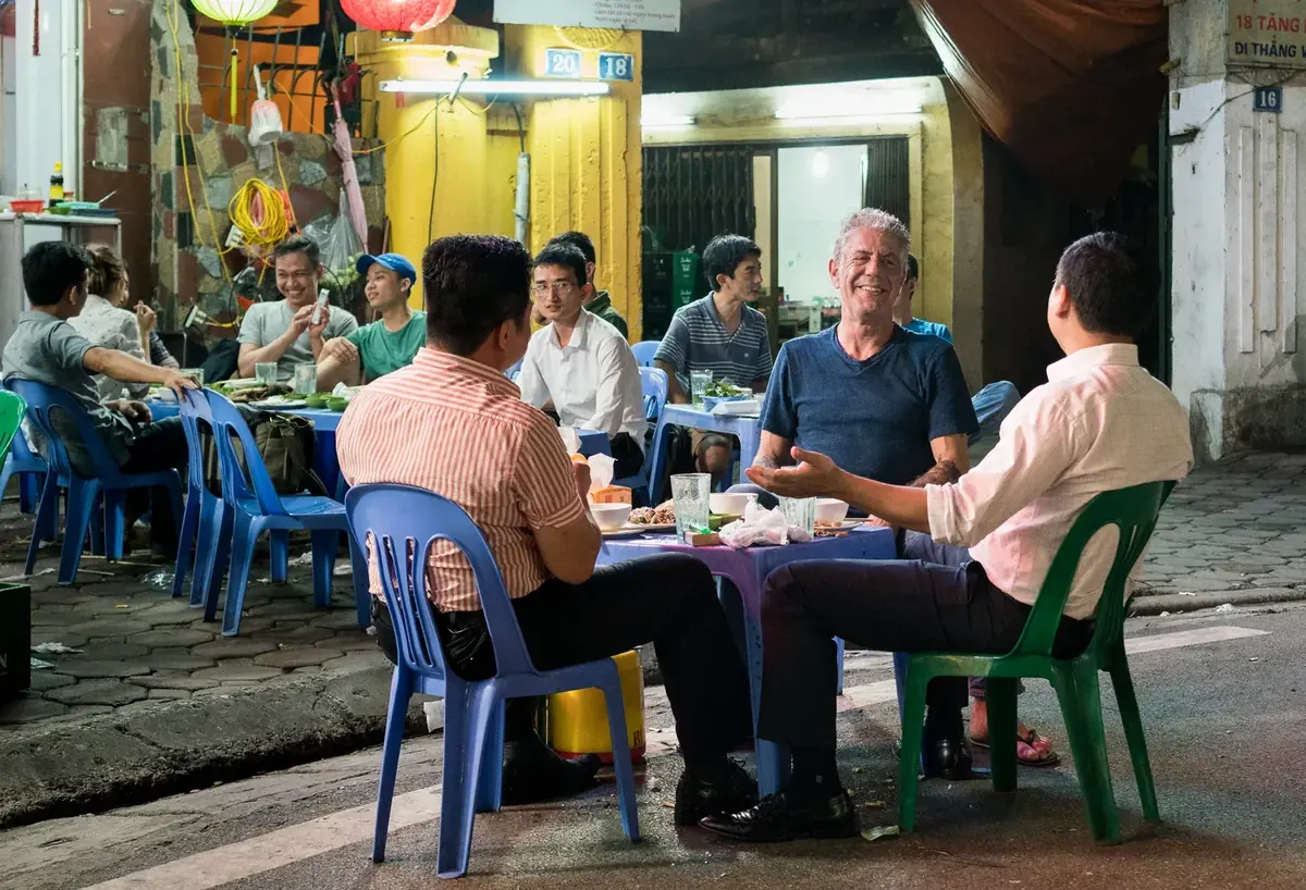 Diners sharing a meal at a street-side restaurant in Hanoi, 2016