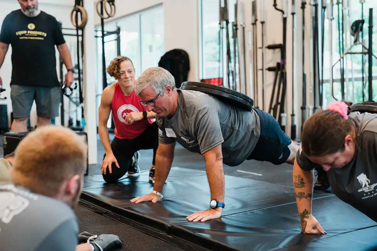 ATA trainer Jenna Muri-Rosenthal leads a floor training session with Wounded Warrior Project athletes
