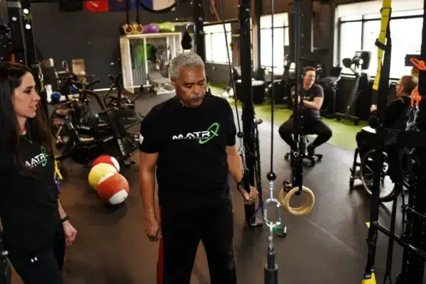 Dr. Krystina Miller, PT, DPT, coaches a client through a ring exercise at Matrx Physical Therapy