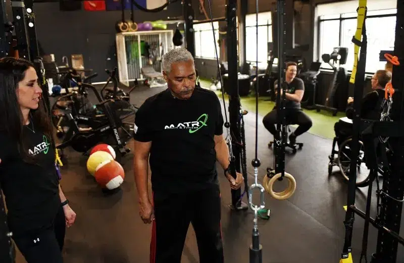 Dr. Krystina Miller, PT, DPT, coaches a client through a ring exercise at Matrx Physical Therapy