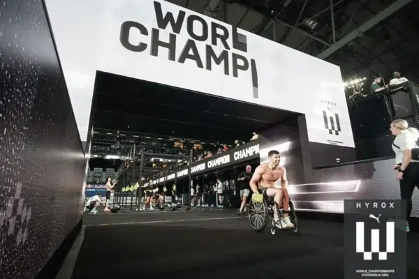 Tom Miazga crosses the finish line in his racing wheelchair at the 2026 HYROX World Championships