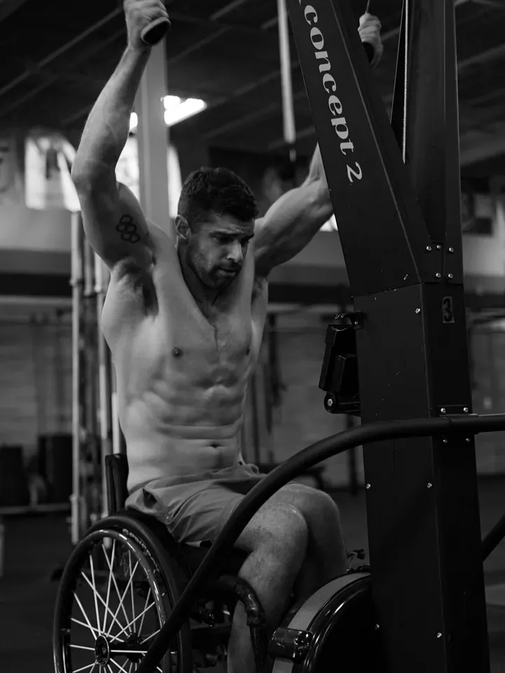 Tom Miazga trains on a SkiErg from his wheelchair
