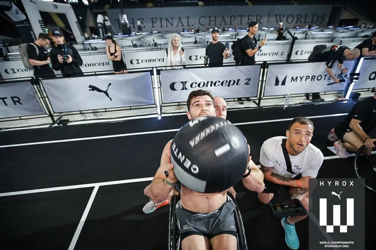 Tom Miazga performs wall ball shots from his wheelchair during the HYROX World Championship race